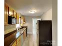 Well-equipped kitchen featuring wooden cabinets and stainless steel appliances at 3138 Morson St, Charlotte, NC 28208