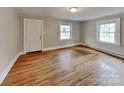 Bright living room with hardwood floors and two windows offering natural light at 3138 Morson St, Charlotte, NC 28208