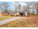 Brick ranch house with carport, on a sloped lot at 3301 10Th Ne Ave, Conover, NC 28613