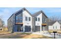 Contemporary townhomes with contrasting dark gray and white facades, individual garages and modern design elements at 3308 Polk And White Rd, Charlotte, NC 28269