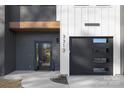 Close-up of modern townhouse showcasing gray siding, black front door, and gray garage door with windows at 3312 Polk And White Rd, Charlotte, NC 28269