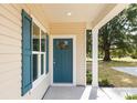 Inviting front entrance with a blue front door, white columns, and manicured landscaping at 338 Hudson St, Shelby, NC 28150