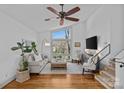 Bright living room with a large window, hardwood floors, and cozy seating at 3723 Annlin Ave, Charlotte, NC 28209