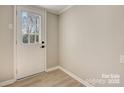 Bright laundry room with white door and vinyl flooring at 3920 Admiral Ave, Charlotte, NC 28205