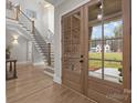 Bright foyer featuring a staircase with iron railings and beautiful hardwood floors at 3945 Ostler Ct, Lancaster, SC 29720