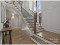 Elegant foyer with a staircase, hardwood floors, and large windows for natural light at 3945 Ostler Ct, Lancaster, SC 29720