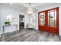 Spacious entryway with hardwood floors, a statement chandelier, and double doors at 423 W Bell St, Statesville, NC 28677