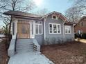 Charming craftsman home with gray siding and a wood front door at 423 W Bell St, Statesville, NC 28677