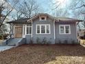 Gray craftsman home with a wood front door and well-maintained lawn at 423 W Bell St, Statesville, NC 28677