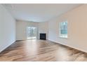 Gathering room with hardwood floors, fireplace, and sliding glass door at 4445 Dusty Orchard Rd, Kannapolis, NC 28081