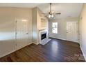 Living room with hardwood floors, fireplace, and neutral color scheme at 4683 Falcon Chase Sw Dr, Concord, NC 28027