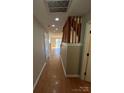 Bright hallway with wood flooring and a staircase leading to the upper level at 5956 Prescott Ct, Charlotte, NC 28269