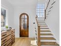 Bright entryway with hardwood floors, staircase, and arched door at 633 Mattie Rose Ln, Charlotte, NC 28204