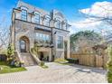 Three-story townhome with brick facade, stone steps, and attached garage at 633 Mattie Rose Ln, Charlotte, NC 28204