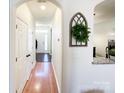 Hardwood floor hallway with access to bedrooms and kitchen at 7562 Silver Arrow Dr, Charlotte, NC 28273