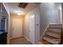 Bright entryway with staircase and storage closet at 7716 Elwood Dr, Charlotte, NC 28227