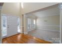 Bright entryway with hardwood floors and access to living room at 8809 Landsdowne Ave, Harrisburg, NC 28075