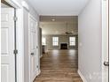 View of the open-concept living room featuring wood flooring and a fireplace at 1007 Astoria Dr, Monroe, NC 28110