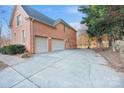 Spacious three-car garage with a wide driveway and a basketball hoop at 1020 James Madison Dr, Weddington, NC 28104