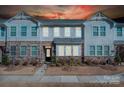 Two story townhome with stone and siding exterior at dusk at 1412 Galloway Rd, Charlotte, NC 28262