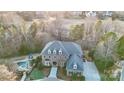 Drone shot of a grand home, highlighting its pristine landscaping, circular driveway, pool, and spacious layout at 14407 Brick Church Ct, Charlotte, NC 28277