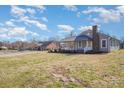 Wide angle exterior shot of gray home with metal roof and spacious yard at 214 E Main St, Cleveland, NC 27013