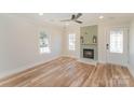 Sunlit living room boasting wood floors, a stylish fireplace, and a welcoming atmosphere at 214 E Main St, Cleveland, NC 27013