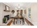 Dining room featuring a fireplace, modern lighting, hardwood floors, and lots of room for entertaining at 2401 High Ridge Rd, Charlotte, NC 28270