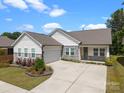 Beautiful one-story home showcasing stone accents, attached garage, and a well-kept lawn with a wide driveway at 315 Skyebrook Ln, Rock Hill, SC 29730