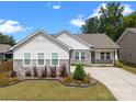 Inviting one-story home featuring stone accents, manicured landscaping, and a spacious driveway under a bright sky at 315 Skyebrook Ln, Rock Hill, SC 29730