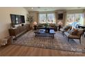 Bright living room features a large rug, comfortable seating, and large windows at 326 Knotty Wood Dr # 66, Monroe, NC 28110