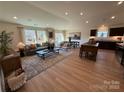 Open concept living room flows from Gathering room to kitchen with modern finishes at 326 Knotty Wood Dr # 66, Monroe, NC 28110