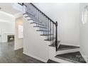 Elegant dark wood staircase with black metal railings at 3316 Brooktree Ln, Indian Trail, NC 28079