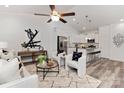Open-concept living area featuring modern decor, leading into a stylish, white kitchen at 404 Killian Ave, Mount Holly, NC 28120