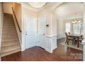 Inviting foyer with hardwood floors, stairs, and view into the dining room at 4194 La Crema Dr, Charlotte, NC 28214