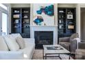 Cozy living room showcasing a fireplace, built-in shelving, and comfortable seating, perfect for Gathering gatherings at 4194 La Crema Dr, Charlotte, NC 28214