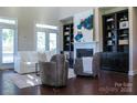 Bright living room with fireplace, built-in bookshelves, and a comfortable sofa for relaxation and entertainment at 4194 La Crema Dr, Charlotte, NC 28214