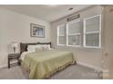 Cozy bedroom with a queen bed, three windows for natural light, and carpet flooring at 4929 Norman Park Pl, Clover, SC 29710
