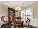 Dining room features dark wood floors, classic furnishings, and natural light at 515 Stickley Pl, Lancaster, SC 29720