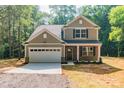Two-story house with gray siding, white garage door, and a brick facade at 5422 Army Rd, Marshville, NC 28103