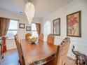 Formal dining room featuring a large wood table and decorative wall art at 6029 Landry Ln, Indian Land, SC 29707