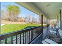 Cozy front porch with rocking chairs, providing a relaxing outdoor space to enjoy the surrounding landscape at 6835 Ingleside Dr, Sherrills Ford, NC 28673