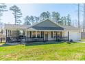 Inviting ranch-style home featuring a rear porch, well-manicured lawn, and attached one-car garage at 6835 Ingleside Dr, Sherrills Ford, NC 28673