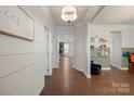 Inviting hallway with hardwood floors, shiplap walls, and views into the open-concept living spaces at 10103 Andres Duany Dr, Huntersville, NC 28078