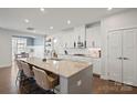 Spacious kitchen with a large center island, seating, white cabinets, and modern stainless appliances at 10103 Andres Duany Dr, Huntersville, NC 28078