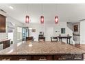 Kitchen island with granite countertop and pendant lighting at 1201 Township Pkwy, Belmont, NC 28012