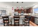 A modern kitchen features stainless steel appliances, granite countertops, and a central island with barstool seating at 1201 Township Pkwy, Belmont, NC 28012
