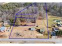 Expansive property featuring a house, outbuildings, trees, and a generous land area bordered in blue at 1902 Old Wilkesboro Rd, Statesville, NC 28625