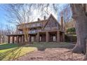 Back exterior featuring a walk out basement and large sunroom at 2700 River Ridge Pl, Fort Mill, SC 29708