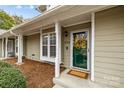 Charming home with a covered entrance, well-maintained landscaping, and natural light with a decorative door at 2745 Tiergarten Ln, Charlotte, NC 28210